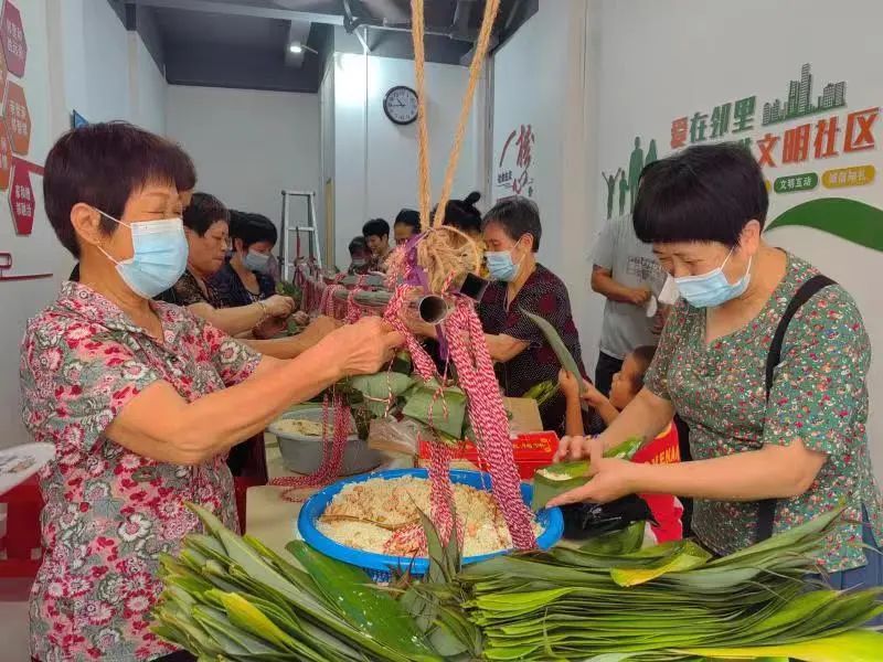  当日上午，在北磨社区荔溪小区里，许多居民早就忙开了，洗粽叶、淘糯米等。原来，他们正在参加“粽香四溢”——包粽子比赛活动（如图）。比赛开始，大家纷纷拿出看家本领，双手麻利地将粽叶卷成漏斗状，用糯米充实压紧，再用细绳一绕、一捆，一个个鲜绿的粽子呈现在眼前。整个活动现场欢声笑语，其乐融融，一片祥和景象。参赛居民俩俩组队，在限定时间内包好粽子超过100个的，就可以领取到一桶油，而他们包好的粽子将全部送给小区居民们，一起分享邻里和睦的“果实”，感受端午节浓浓的非遗文化。         此外，社工还与小区儿童开展“童”话端午活动、粽享夏日游园等，在社工、志愿者的引导下，一起分享端午故事、成语，展开旱地龙舟、巧运龙珠、袋鼠跳、两人三足、投壶等游戏互动，好不欢乐。